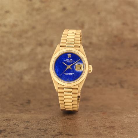 Rolex. A lady's 18K gold automatic calendar bracelet watch